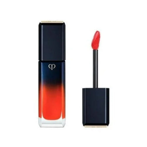 Red lipsticp gloss with black applicator on a white background