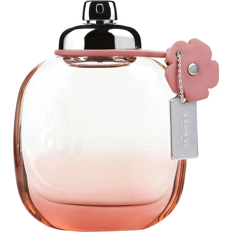 COACH FLORAL BLUSH Perfume bottle with pink gradient design and floral charm on a white background