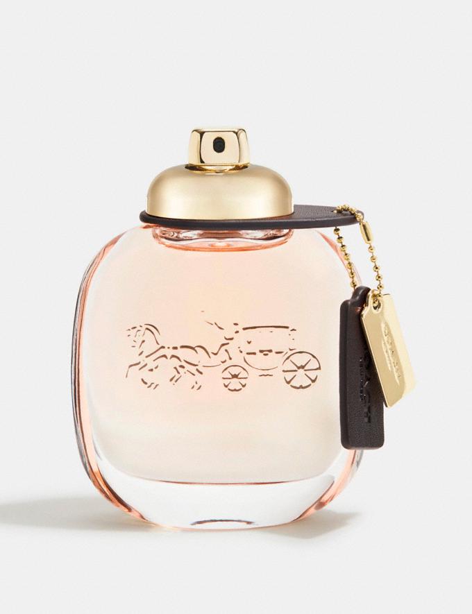 COACH NEW YORK Perfume bottle with gold cap and logo on a light background