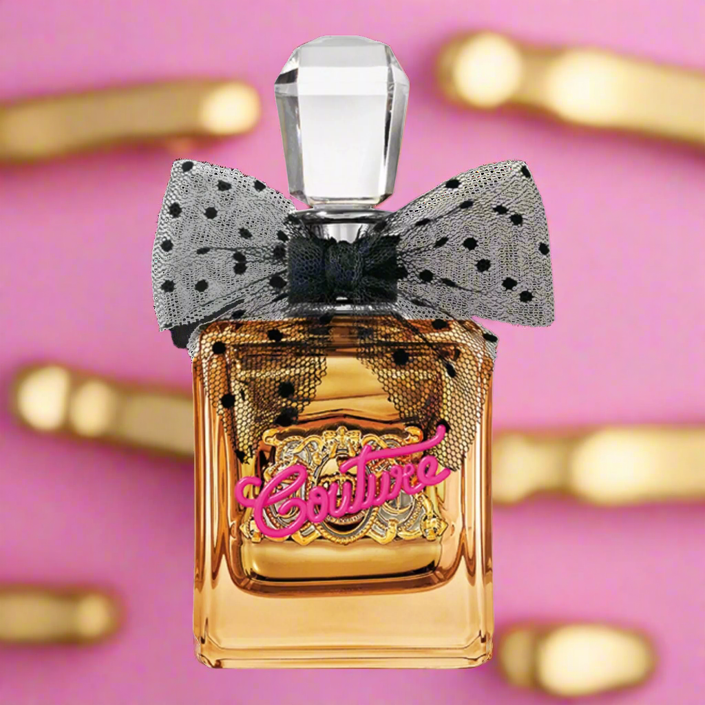 Gold perfume bottle with a black bow on a pink background