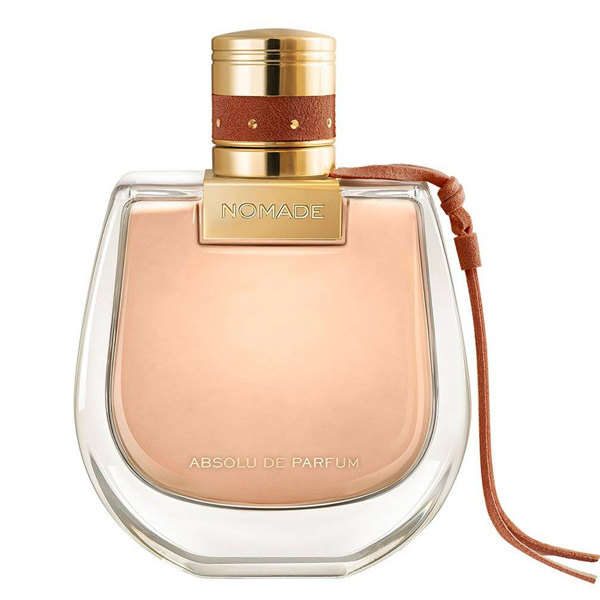 Perfume bottle labeled 'Nomade' with a gold cap and brown strap on a white background