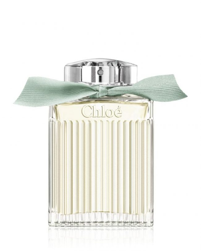 Chloe perfume bottle with a silver cap and green ribbon on a white background