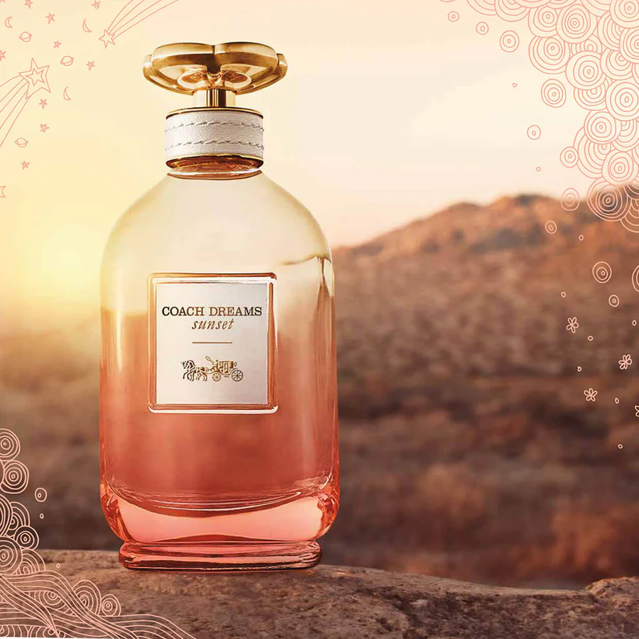 Coach Dreams Sunset perfume bottle with a scenic background