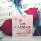 Coach floral blush Eau de Parfum box with red roses and music sheet background