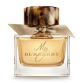 Burberry perfume bottle with gold cap, elegant bow and label on a white background 