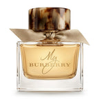 Burberry perfume bottle with gold cap, elegant bow and label on a white background 