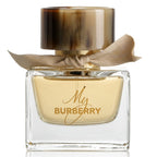 Burberry perfume bottle with gold cap, elegant bow and label on a white background 