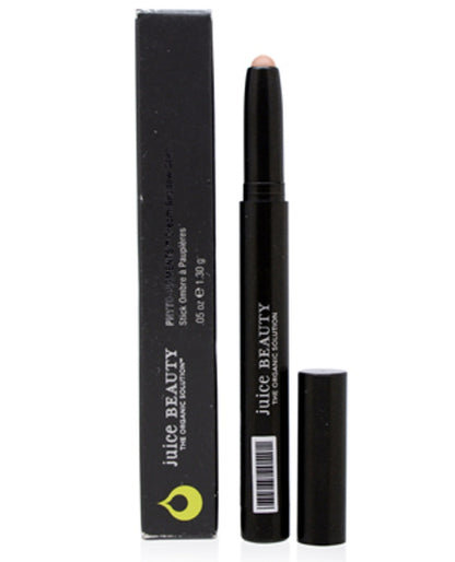 Black cosmetic stick with cap and Juice Beauty packaging on a white background