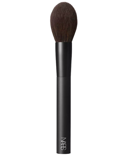 Black makeup brush with brown bristles on a white background, featuring the NARS logo.