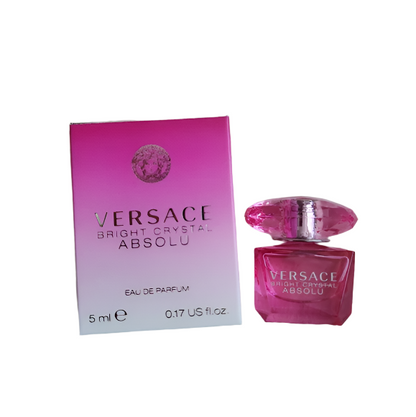 Versace Bright Crystal Absolu perfume bottle and packaging with flowers in the background