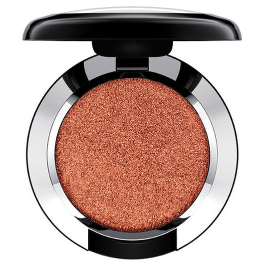Compact makeup powder in a round container with a metallic finish on a white background