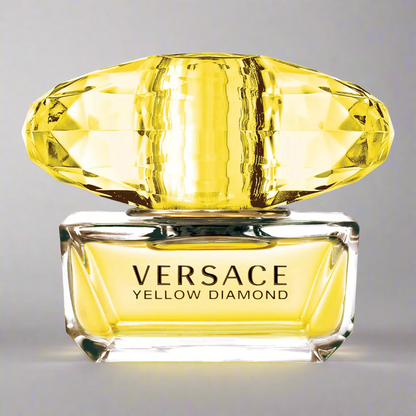 Versace Yellow Diamond perfume bottle with a yellow gemstone on a gray background